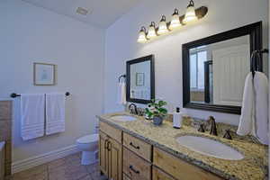 Bathroom featuring tile patterned flooring, toilet, shower and jetted tub