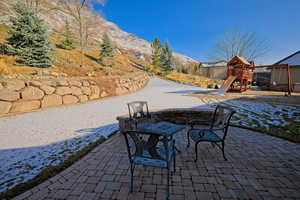 View of patio featuring a mountain view and a playground