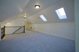 Bonus room featuring lofted ceiling with skylight, and brand new carpet floors