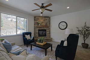 Living room featuring a fireplace, light carpet and private mountain views