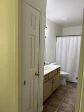 Full bathroom with vanity, visible vents, tile patterned flooring, a textured ceiling, and toilet