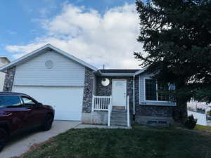 Single story home featuring brick siding, concrete driveway, a front yard, and a garage