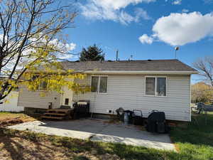 Back of property with a patio area and fence