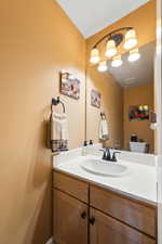 Bathroom featuring vanity, toilet, and visible vents