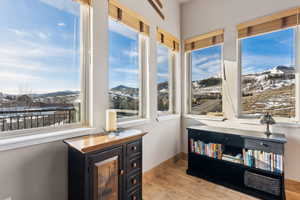 Sitting room featuring a mountain view, baseboards, and wood finished floors