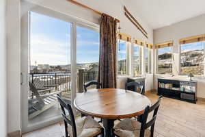 Dining area with a mountain view and light wood finished floors