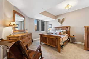 Bedroom with light carpet and baseboards