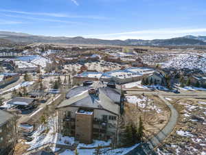 Snowy aerial view featuring a residential view and a mountain view