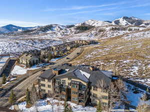 Snowy aerial view featuring a residential view and a mountain view