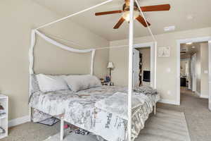 Bedroom featuring a ceiling fan, carpet, visible vents, and baseboards