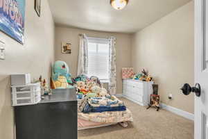 Carpeted bedroom with baseboards