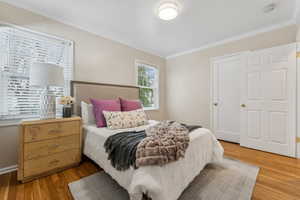 Bedroom featuring light wood-style floors and ornamental molding