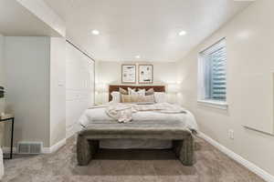 Carpeted bedroom featuring recessed lighting, baseboards, visible vents, and a closet