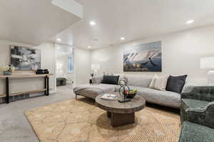 Living area featuring recessed lighting, baseboards, and carpet flooring