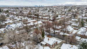 Snowy aerial view featuring a mountain view and a residential view