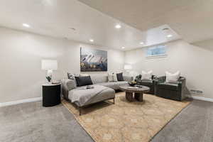 Living room with recessed lighting, baseboards, visible vents, and carpet floors