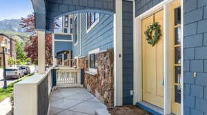 Doorway to property featuring a mountain view and covered porch