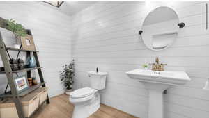 Bathroom featuring toilet and wood finished floors