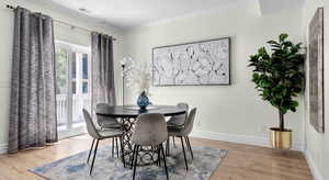 Dining area with visible vents, ornamental molding, baseboards, and wood finished floors