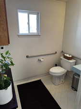 Half bathroom featuring toilet and baseboards
