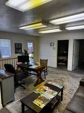 Home office featuring a textured ceiling
