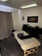 Carpeted bedroom with a textured ceiling