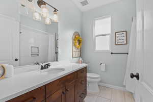 Bathroom with tile patterned flooring, toilet, visible vents, vanity, and baseboards