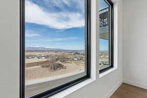 Interior space with a mountain view, wood finished floors, and baseboards