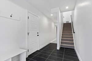 Stairs featuring tile patterned flooring, recessed lighting, baseboards, and visible vents