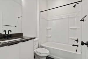 Full bath featuring shower / bathing tub combination, toilet, and vanity