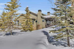 View of snowy exterior with board and batten siding