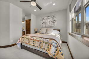 Bedroom with recessed lighting, connected bathroom, baseboards, and carpet flooring
