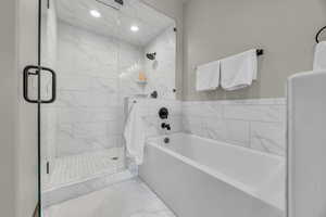 Full bathroom featuring a garden tub and a stall shower