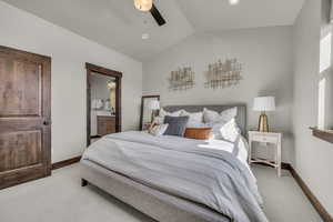 Bedroom featuring baseboards, carpet, and vaulted ceiling