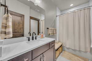 Full bath featuring vanity, shower / bath combo, visible vents, and tile patterned flooring