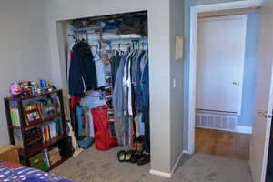 Bedroom closet featuring with view to hall