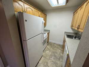Kitchen featuring white appliances and light countertops