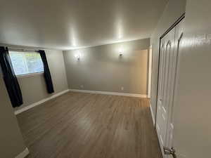Spare room featuring wood finished floors and baseboards