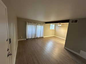 Spare room with wood finished floors and a ceiling fan