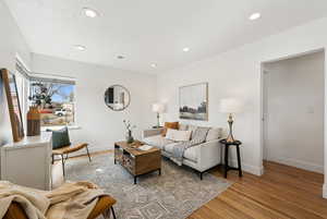 Living area with ample natural light and beautifully refinished hardwood floors.