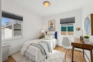 Main level bedroom with beautiful hardwood flooring and plenty of natural light.