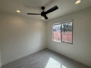 Spare room with recessed lighting, light colored carpet, baseboards, and ceiling fan