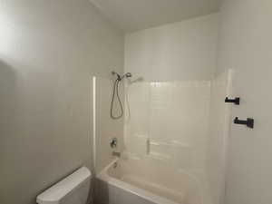 Bathroom featuring shower / washtub combination and toilet