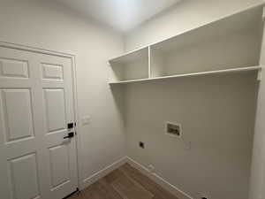 Washroom featuring baseboards, laundry area, hookup for a washing machine, dark wood-style floors, and electric dryer hookup