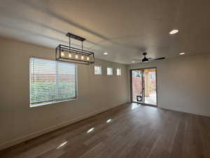 Spare room featuring recessed lighting, a textured ceiling, baseboards, and wood finished floors