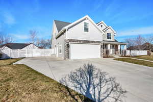 View of front of home featuring plenty of parking space.
