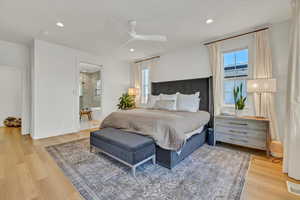 Bedroom with light wood finished floors, visible vents, multiple windows, and recessed lighting