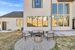Rear view of house with an outdoor living space, stucco siding, a patio, and roof with shingles