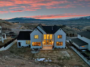 Exterior space with a mountain view, stucco siding, and fence