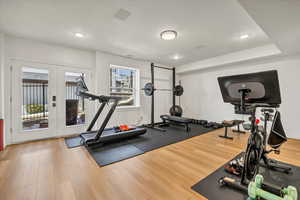 Workout area with recessed lighting, wood finished floors, baseboards, and french doors